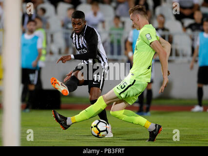 Belgrade, Serbia. 26th July, 2018. Partizan's Ricardo Gomes (L) shoots the ball past Trakai's Justinas Janusevskis during the second qualifying round UEFA Europa League football match in Belgrade, Serbia, July 26, 2018. Partizan won 1-0. Credit: Predrag Milosavljevic/Xinhua/Alamy Live News Stock Photo