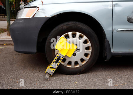A Paylock SmartBoot Wheel Clamp on a Car Stock Photo
