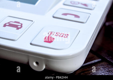 sos Red button on a dirty old panel, selective focus Stock Photo