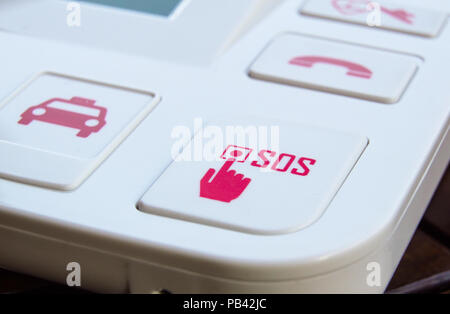 sos Red button on a dirty old panel, selective focus Stock Photo