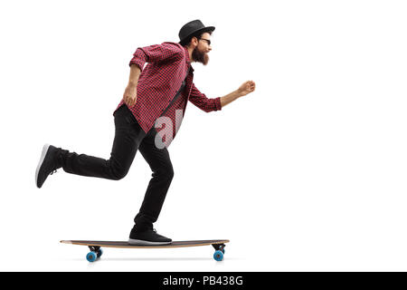 Full length profile shot of a hipster riding a longboard isolated on white background Stock Photo