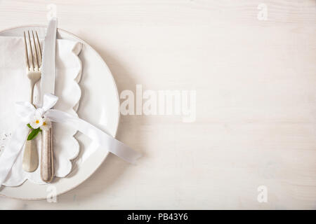 Holiday dinner. Table place setting with empty plates, silver fork and knife, copy space Stock Photo