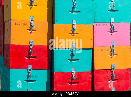 Brightly coloured  beehives stacked in a pile. Near Kardamyli in the Outer Mani, Peloponnese, Greece Stock Photo