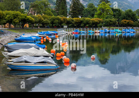 A cold day in July with boats docked and anchored in the Weesen harbour. Stock Photo