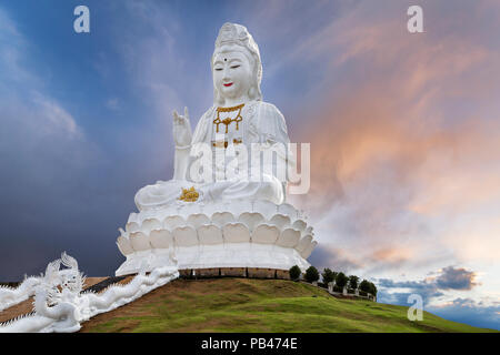 Big Guan Yin Statue representing goddess of compassion and mercy, at the sunset, in Chiang Rai, Thailand. Stock Photo