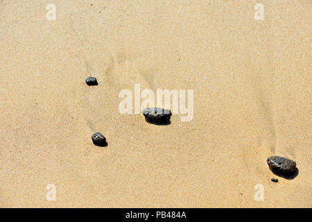 Beach stones and runoff patterns on Punta Cormorant beach, Galapagos Islands National Park, Floreana Island, Ecuador Stock Photo