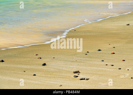 Beach stones and runoff patterns on Punta Cormorant beach, Galapagos Islands National Park, Floreana Island, Ecuador Stock Photo