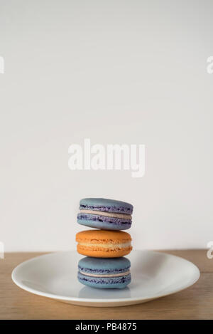 Stacked Macaroons Making a Blue and Orange Sandwich of Delicious Proportions - Set of Three Stock Photo