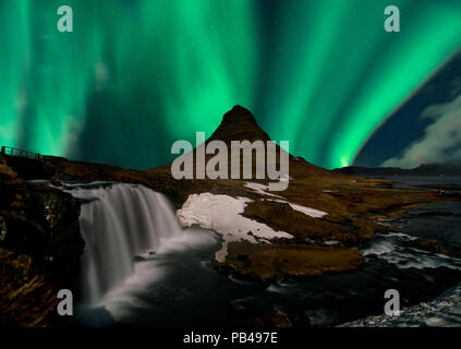 Northern lights aurora borealis appear over Mount Kirkjufell in Iceland. Stock Photo