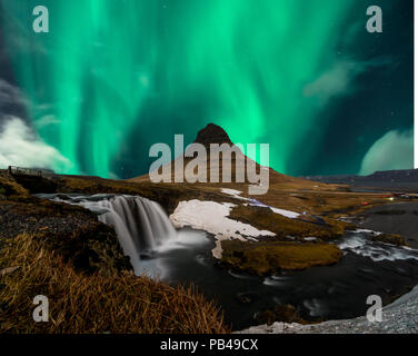 Northern lights aurora borealis appear over Mount Kirkjufell in Iceland. Stock Photo
