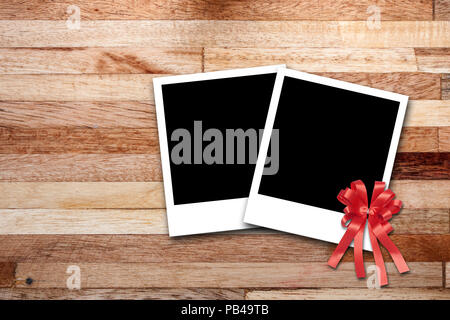 Blank photo frames on wood background Stock Photo