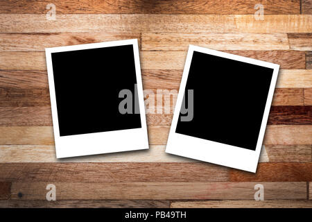 Blank photo frames on wood background Stock Photo
