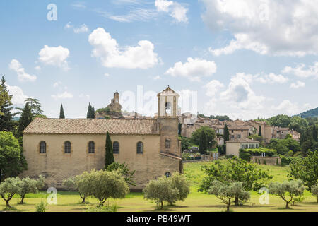 The village of Lourmarin with a small church in front - Provence, France Stock Photo