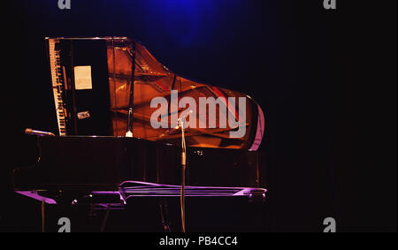 Closeup view of big stage concert piano, opened and miked, ready for performance. Stock Photo