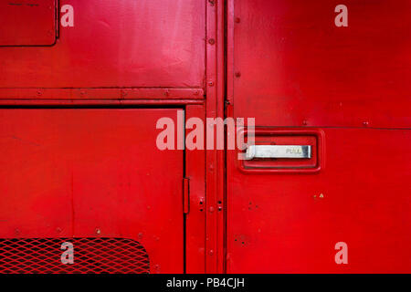 Aboard a red fire truck with doors and chrome handles and protective grille Stock Photo