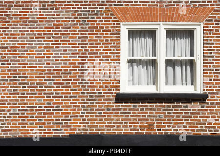 Traditional sash window and red brick wall background with copyspace Stock Photo