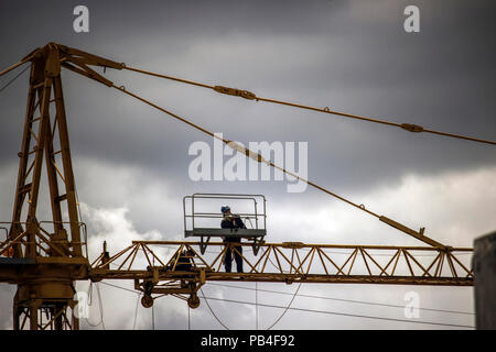 Belgrade, Serbia - Workers repairing a construction crane high above the ground Stock Photo