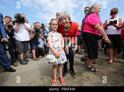 Prime Minister Theresa May with Anest Jones, 6, from the Brecon Beacons, during a visit to the Royal Welsh Agricultural Show at the Royal Welsh Showground in LLanelwedd, Powys.
