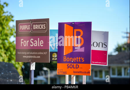 Estate Agents boards of Fox & Sons , Purple Bricks , Bonnetts and Brand Vaughan outside properties for sale in Brighton Stock Photo