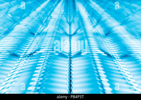 Abstract blue futuristic background made by zooming a camera pointed at modern building at night. Stock Photo