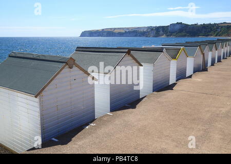 Row of white beach huts in Seaton, Devon Stock Photo