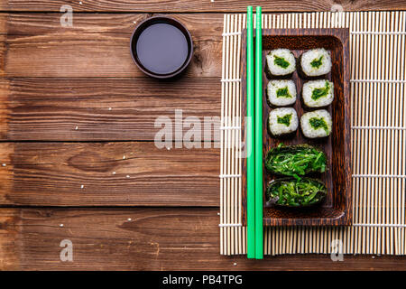 Rolls , chopsticks on wooden background Stock Photo