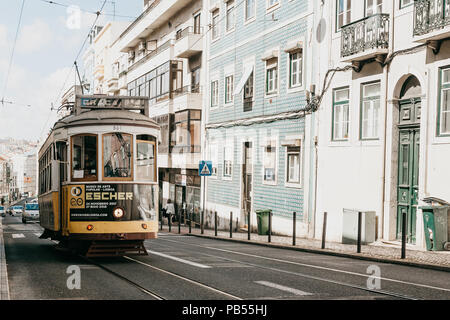 Portugal, Lisbon, June 01, 2018: A traditional yellow old-fashioned tram ride down the city street. Stock Photo