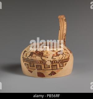 Fragment of a terracotta oinochoe (jug). Culture: East Greek, Milesian, Fikellura. Dimensions: H. of a 5 3/4 in. (14.6 cm); length of b 3 1/2 in. (8.9 cm). Date: ca. 560-550 B.C..  On the shoulder, deer attacked by sphinxes and griffins, water birds  On the body, bull attacked by lion  This fine fragment represents an early phase in the development of Fikellura pottery. In the animal groups as well as the drawing, there is a vitality that later subsides. The name Fikellura derives from a site on the island of Rhodes to which this fabric has been attributed. It is now established that the cente Stock Photo