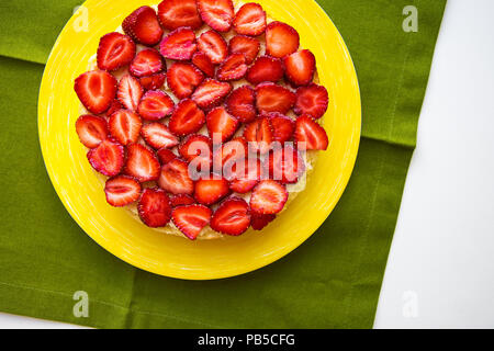 Beautiful strawberry cake is on the table, green napkin Stock Photo