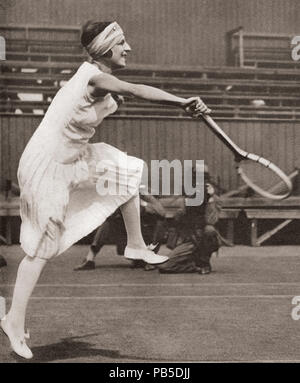 Suzanne Rachel Flore Lenglen, 1899 – 1938.  French tennis player.  Seen here playing at Wimbledon in 1919 when she won the title.  From These Tremendous Years, published 1938. Stock Photo
