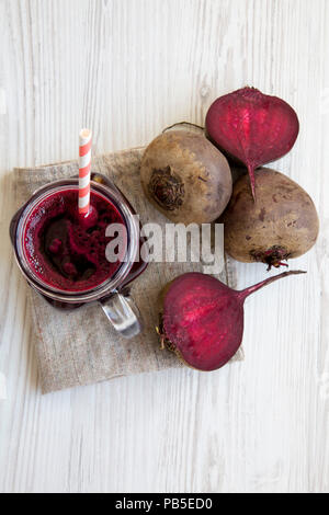 Glass jar mug filled with beetroot smoothie, top view. From above, overhead. Stock Photo