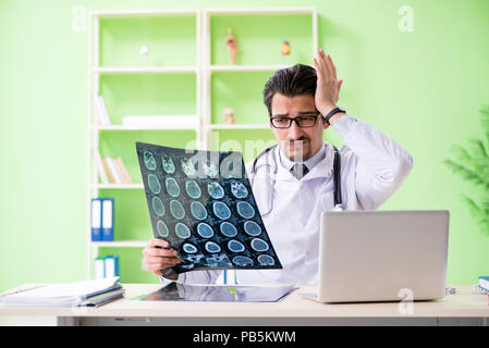 Doctor radiologist looking at x-ray scan in hospital Stock Photo