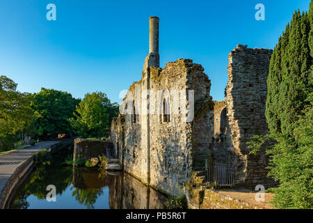 Christchurch Dorset England July 23, 2018 The Norman house, and mill stream Stock Photo