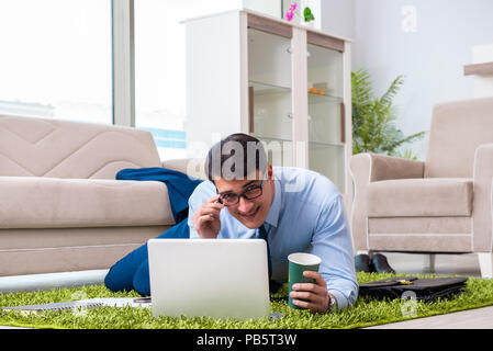 Businessman taking work home and working overtime Stock Photo
