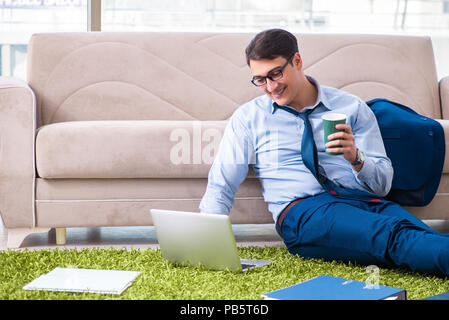 Businessman taking work home and working overtime Stock Photo