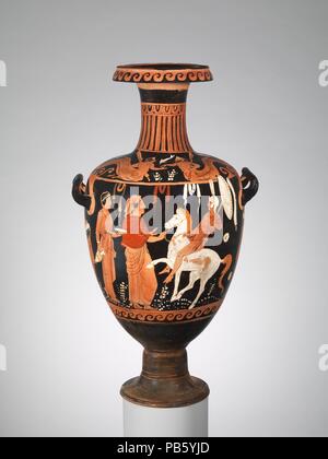 Terracotta hydria (water jar). Culture: Greek, South Italian, Campanian. Dimensions: H. 23 1/2 in. (59.7 cm). Date: ca. 350-320 B.C..  On the body, return of a mounted warrior  On the shoulder, tritons  Under the handles, head of a woman  An Italic warrior, wearing the characteristic plumed helmet, is greeted by a woman who holds the horse's bridle and an attendant carrying the oinochoe and phiale (jug and libation bowl) for an offering. The scene is remarkable for the freshness of the color. Of equal note are the triton and tritoness on the shoulder. The rarity of marine mythology in South It Stock Photo