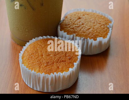 butter cupcake and ice coffee on table Stock Photo