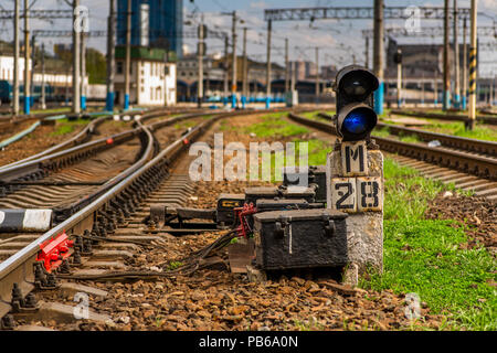 blue signal of the semaphore on the background of the railway track