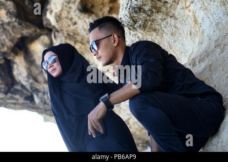 Muslim Couple in the mountains Rock with Black Dress Stock Photo