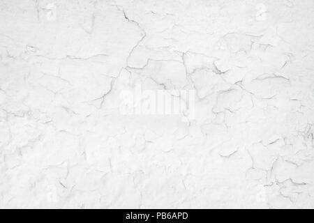 Cracked paint on a white wall close up. Texture and background Stock Photo