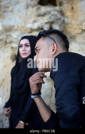 Muslim Couple in the mountains Rock with Black Dress Stock Photo