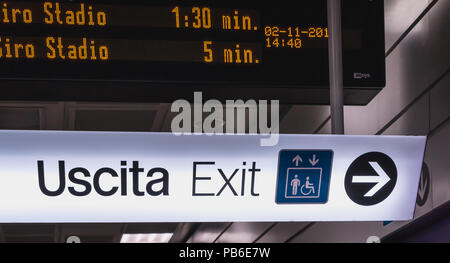 Milan, Italy - November 2, 2017: In the corridors of the subway, a bright billboards indicate the exit on a fall day Stock Photo