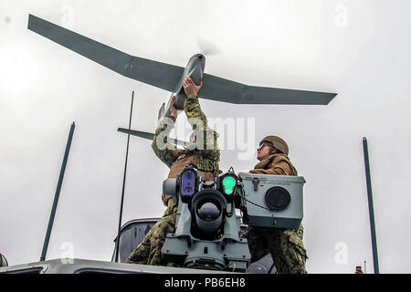 Chief Boatswain’s Mate and Engineman 2nd Class during the launch of the unmanned aerial vehicle (UAV) during the UAV training exercise Stock Photo