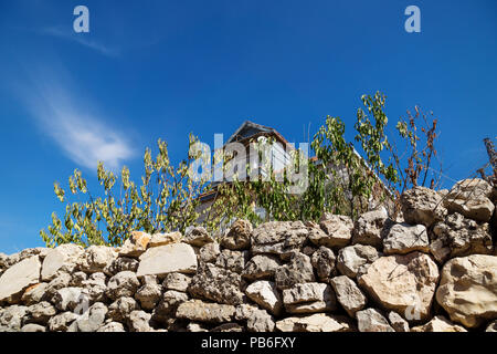 Traditional lebanese house with green dry fence with blue sky in Rachaiya, Bekaa valley, Lebanon Stock Photo