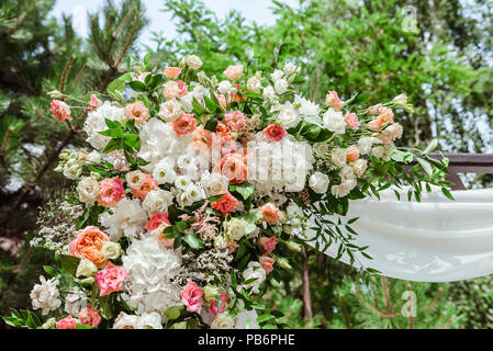 Magnificent fresh wedding flowers. High vertical composition from flowers on a wedding arch Stock Photo