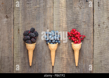 Fresh fruit and berries in ice cream cones. Healthy summer food concept.Top view with space for text. Stock Photo