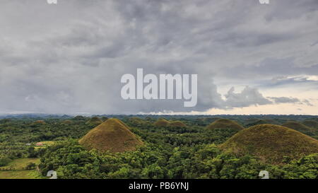 Chocolate Hills geological formation-rolling terrain of haycock hills-conical shaped limestone mounds grass covered-it turns chocolate brown in the dr Stock Photo