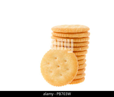 Round salted crackers stacked with one cracker in front isolated on white Stock Photo