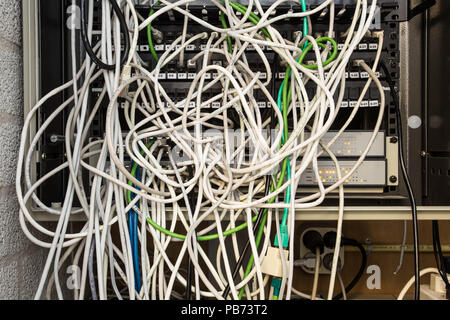 Chaos of network cables tangled computer Stock Photo