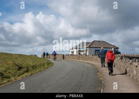Walkers and cyclist by the cafe on the marine drive at Great Orme's Head, Llandudno, North Wales, UK. Stock Photo